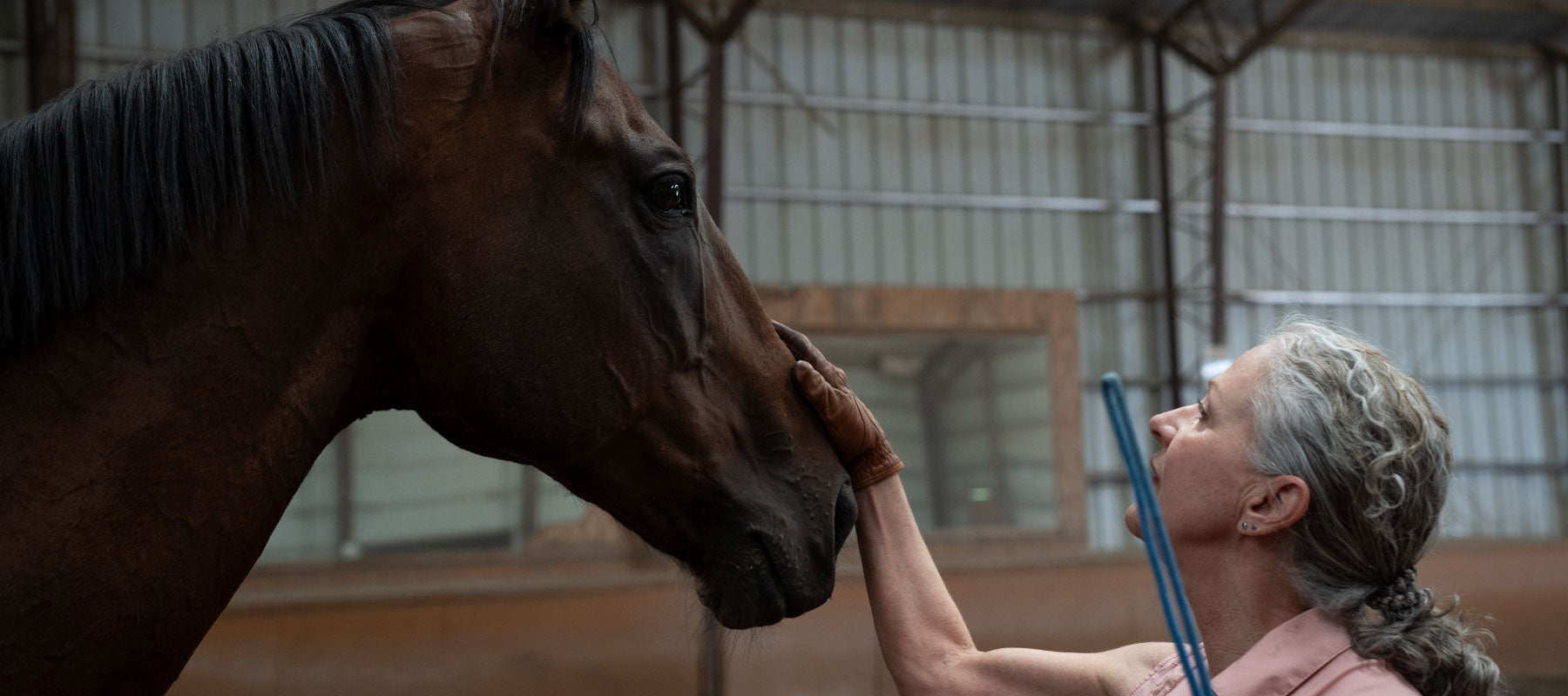 Maggie and her horse Izzy in a barn