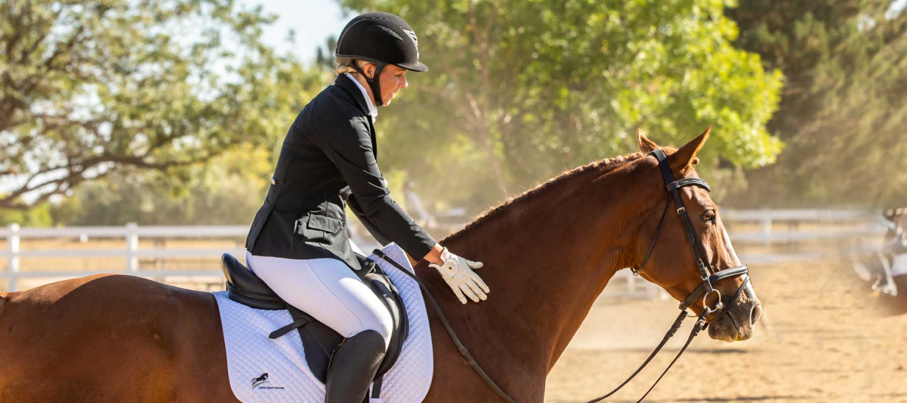 Woman riding a brown horse outdoors, showcasing proper equestrian care and companionship