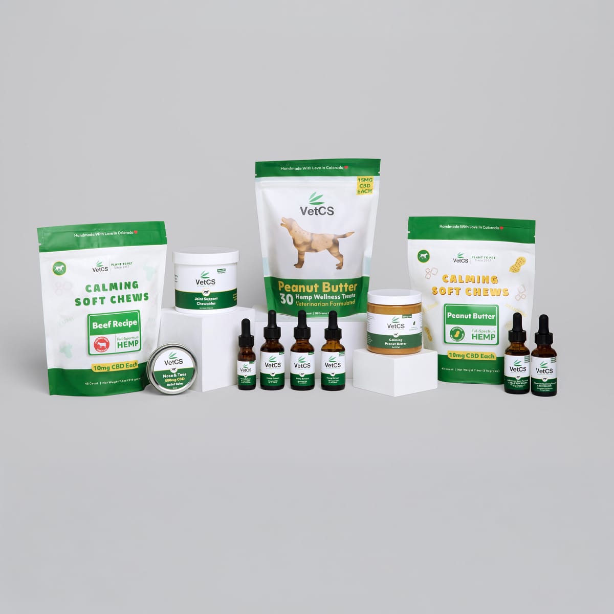 Full lineup of VetCS CBD for dogs including oils, chews, peanut butter, and topical products displayed on a neutral background.