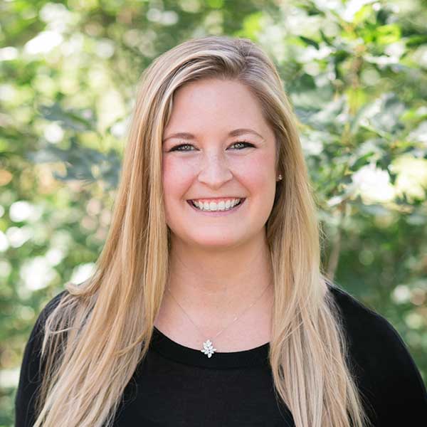 Trish Wilhelm outside with a green background