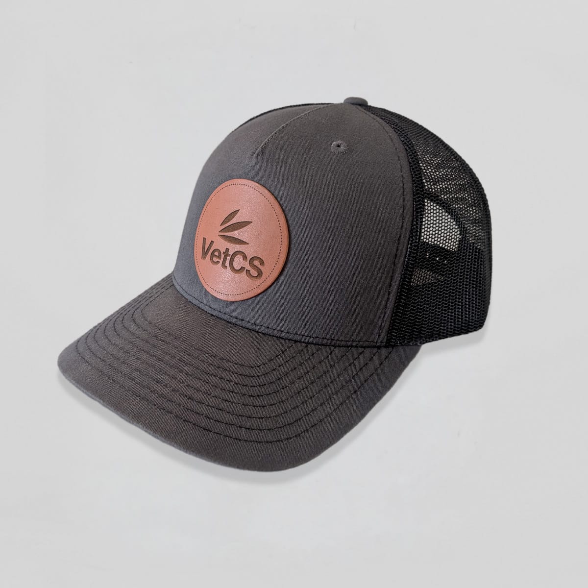 Gray cap with a brown leather patch featuring 'VetCS' logo on a light gray background