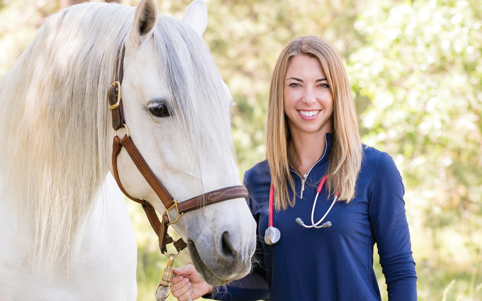 Dr. Chelsea with a horse outdoors.