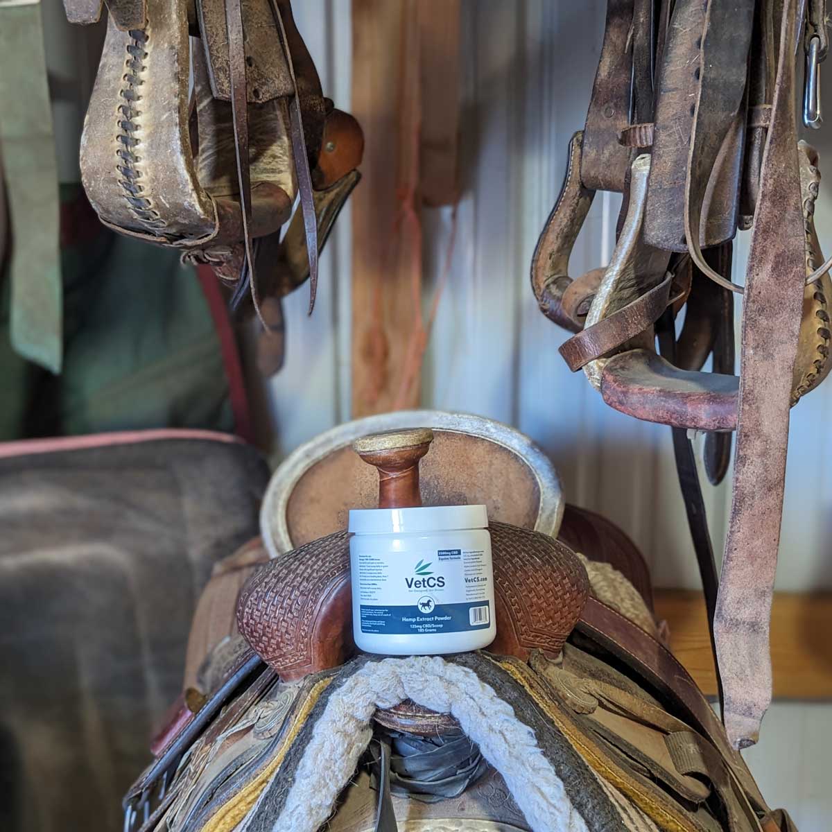 VetCS CBD Horse Powder sitting on a horse saddle 
