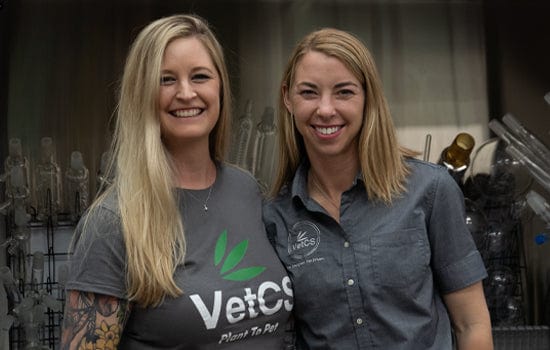 VetCS co-founders standing together in their lab, representing the veterinary-led research and formulation behind every product.