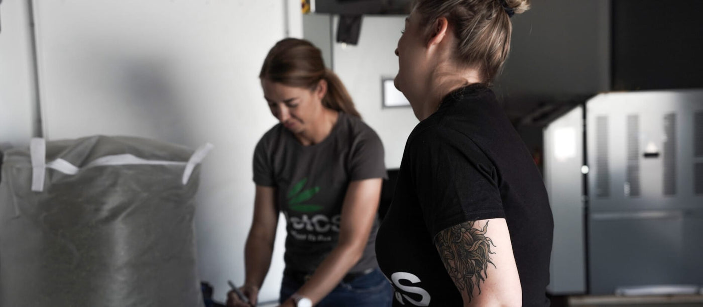 Chelsea and Trish VetCS founders in a room with a large gray bag and equipment in the background