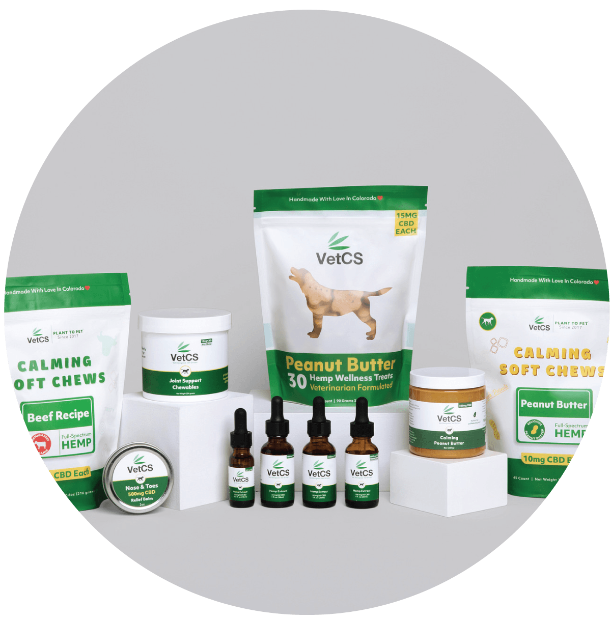 Collection of VetCS pet products including chews, treats, and supplements on a gray background.