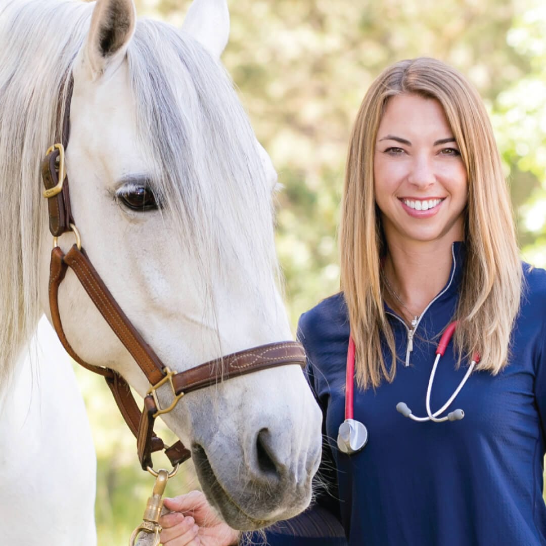 Dr. Chelsea Luedke with horse demonstrating veterinary care and expertise